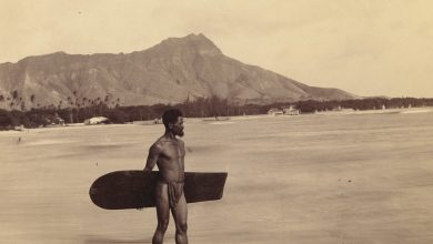 hawaiian standing with an alaia surfboard